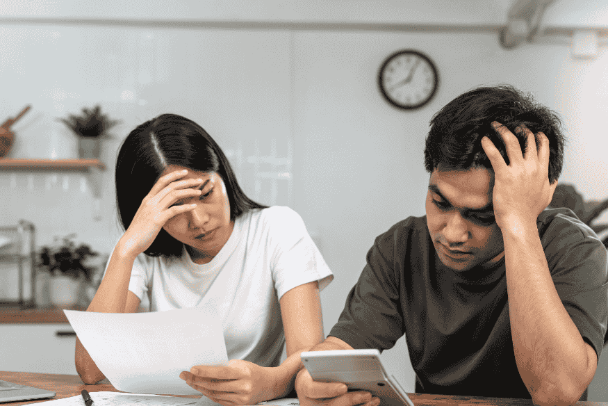 Casal preocupado com dívidas e análise de crédito por estar negativado no CPF