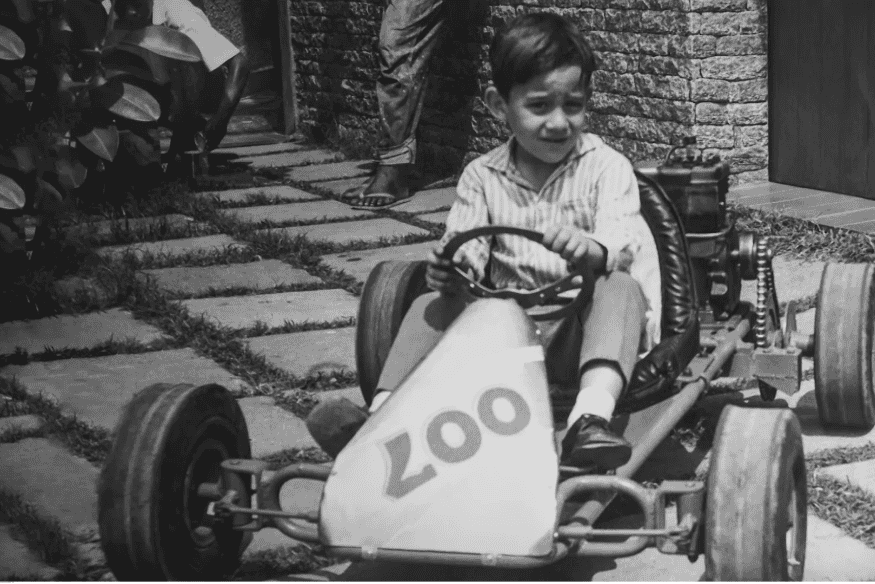 Ayrton Senna criança pilotando um kart simples no quintal de casa.