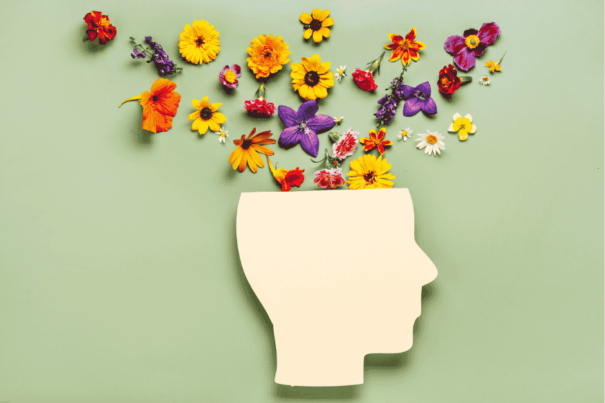 Ilustração de cabeça humana com flores coloridas saindo de dentro, simbolizando saúde mental.